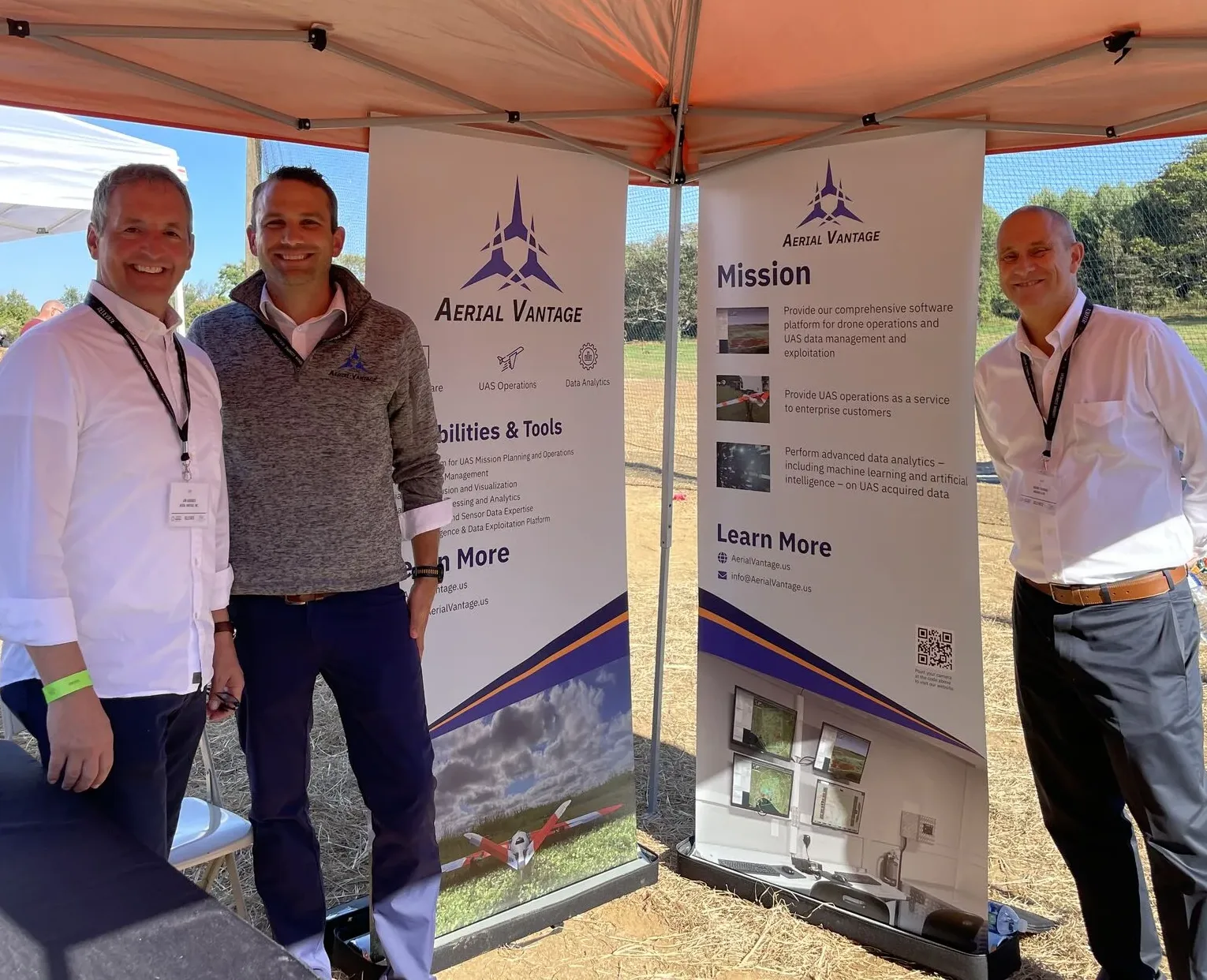 Aerial Vantage team with drone data branded banners at a trade show